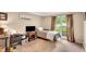 Cozy bedroom with neutral walls, carpet flooring, and a bright window dressed with dark curtains at 1050 Chestnut Hill Sw Cir, Marietta, GA 30064