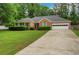 Charming brick home with manicured lawn and a two-car garage, perfect for suburban living at 1050 Chestnut Hill Sw Cir, Marietta, GA 30064