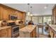 Kitchen featuring stainless appliances, wood cabinetry, granite countertops, and an open layout at 1050 Chestnut Hill Sw Cir, Marietta, GA 30064