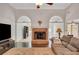 Cozy living room with a brick fireplace, hardwood floors, and arched doorways at 1050 Chestnut Hill Sw Cir, Marietta, GA 30064