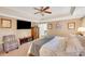 Spacious main bedroom featuring a ceiling fan, carpeted floors, and a comfy sitting chair at 1050 Chestnut Hill Sw Cir, Marietta, GA 30064