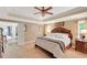 Bright main bedroom with a tray ceiling, neutral walls, and a large comfortable bed at 1050 Chestnut Hill Sw Cir, Marietta, GA 30064