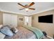Relaxing bedroom featuring a ceiling fan, large window, and a cozy bed with stylish bedding at 1050 Chestnut Hill Sw Cir, Marietta, GA 30064