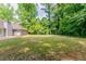 The backyard features a lush lawn and mature trees, perfect for outdoor activities and relaxation at 2950 Camary Place Se Dr, Conyers, GA 30094
