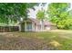 The backyard features a lush lawn and mature trees, perfect for outdoor activities and relaxation at 2950 Camary Place Se Dr, Conyers, GA 30094