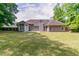 The backyard features a lush lawn and mature trees, perfect for outdoor activities and relaxation at 2950 Camary Place Se Dr, Conyers, GA 30094