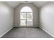 A bedroom with neutral carpet features a large window and natural light at 2950 Camary Place Se Dr, Conyers, GA 30094
