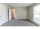 Bright bedroom features a double door closet, a window, and soft gray carpet at 2950 Camary Place Se Dr, Conyers, GA 30094