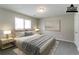 Staged bedroom with a large bed, two side tables, and a painting at 2950 Camary Place Se Dr, Conyers, GA 30094