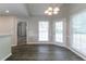 Dining area featuring wood floors, wainscoting, and modern light fixture at 2950 Camary Place Se Dr, Conyers, GA 30094