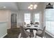 Staged dining area with four chairs, table, and wood floor near kitchen at 2950 Camary Place Se Dr, Conyers, GA 30094