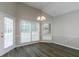 Bright dining area featuring wood floors, a modern light fixture, and multiple windows at 2950 Camary Place Se Dr, Conyers, GA 30094