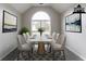 Bright dining room featuring a modern table with seating for eight and a large arched window at 2950 Camary Place Se Dr, Conyers, GA 30094