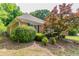 A view of the rear exterior of the property shows mature landscaping and healthy lawn at 2950 Camary Place Se Dr, Conyers, GA 30094