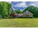 Charming single-story home with a well-manicured lawn and lush, mature trees at 2950 Camary Place Se Dr, Conyers, GA 30094