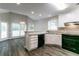 Efficient kitchen with white cabinets, black appliances, and an adjacent breakfast area at 2950 Camary Place Se Dr, Conyers, GA 30094