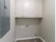 Neutral laundry room with upper cabinets and connections for a washing machine and dryer at 2950 Camary Place Se Dr, Conyers, GA 30094