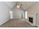 Open living room with a ceiling fan, fireplace, vaulted ceilings, and neutral-colored carpet at 2950 Camary Place Se Dr, Conyers, GA 30094