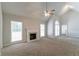 Bright living room featuring a fireplace with vaulted ceiling and neutral carpeting at 2950 Camary Place Se Dr, Conyers, GA 30094