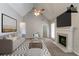 Virtually staged living room featuring a fireplace, ceiling fan, and modern decor at 2950 Camary Place Se Dr, Conyers, GA 30094