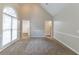 Spacious living room with neutral carpet and tall arched window providing natural light at 2950 Camary Place Se Dr, Conyers, GA 30094