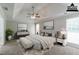 Virtually staged main bedroom featuring a tray ceiling, ceiling fan and modern decor at 2950 Camary Place Se Dr, Conyers, GA 30094