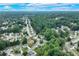 Overhead shot of a suburban neighborhood with tree-lined streets, well-maintained homes and lush greenery at 3238 Sharp Creek Ln, Buford, GA 30519