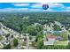 Aerial view with I-85 overlay showcasing a neighborhood surrounded by mature trees with a home inset at 3238 Sharp Creek Ln, Buford, GA 30519