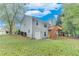 Well-maintained home exterior with a sprawling lawn, complemented by a wood deck and lush trees at 3238 Sharp Creek Ln, Buford, GA 30519