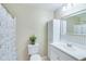 Well-lit bathroom featuring a white vanity, decorative shower curtain, and neutral wall color at 3238 Sharp Creek Ln, Buford, GA 30519