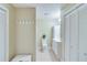 Hallway bathroom featuring white fixtures, cabinets, and tile floors at 3238 Sharp Creek Ln, Buford, GA 30519