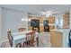 Cozy dining area featuring wood floors, a ceiling fan, and direct access to the updated kitchen space at 3238 Sharp Creek Ln, Buford, GA 30519