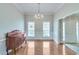 Elegant dining room with hardwood floors, a classic chandelier, and detailed wainscoting at 3238 Sharp Creek Ln, Buford, GA 30519