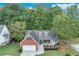 Charming single-Gathering home showcasing brick and siding with a well-manicured lawn and mature trees at 3238 Sharp Creek Ln, Buford, GA 30519