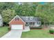 Charming single-Gathering home showcasing brick and siding with a well-manicured lawn and mature trees at 3238 Sharp Creek Ln, Buford, GA 30519