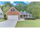 Charming one-story home featuring brick accents, a two-car garage, and a well-manicured lawn in a quiet neighborhood at 3238 Sharp Creek Ln, Buford, GA 30519