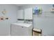 Functional laundry room with white cabinets, shelving, washer and dryer at 3238 Sharp Creek Ln, Buford, GA 30519