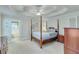 Serene main bedroom featuring a tray ceiling, plush carpeting, and an en-suite bathroom at 3238 Sharp Creek Ln, Buford, GA 30519