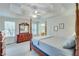 Spacious main bedroom with a tray ceiling, a ceiling fan and wooden furniture at 3238 Sharp Creek Ln, Buford, GA 30519
