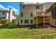 Two-story home boasts a deck overlooking a well-maintained lawn, enhanced by vibrant greenery and natural light at 416 Wilfawn Way, Avondale Estates, GA 30002