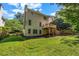 Expansive green backyard featuring a wooden deck, lush landscaping, and mature trees for outdoor living at 416 Wilfawn Way, Avondale Estates, GA 30002