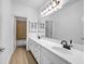 Bright bathroom featuring a double sink vanity, large mirror, and modern fixtures at 416 Wilfawn Way, Avondale Estates, GA 30002