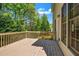 Wooden deck overlooking a lush green backyard offers a serene space for relaxation and outdoor enjoyment at 416 Wilfawn Way, Avondale Estates, GA 30002