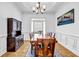 Formal dining room featuring hardwood floors, wainscoting, and a large window for natural light at 416 Wilfawn Way, Avondale Estates, GA 30002