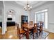 Formal dining room featuring hardwood floors, wainscoting, and a large window for natural light at 416 Wilfawn Way, Avondale Estates, GA 30002