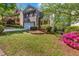 Two-story home with brick and siding exterior, a two-car garage, and lush landscaping for enhanced curb appeal at 416 Wilfawn Way, Avondale Estates, GA 30002