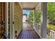 Inviting front porch featuring wood flooring, a white railing, and a charming view, enhancing curb appeal at 416 Wilfawn Way, Avondale Estates, GA 30002