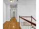Well-lit hallway featuring hardwood floors and a staircase with wooden railing at 416 Wilfawn Way, Avondale Estates, GA 30002