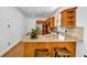 Modern kitchen with tan countertops, breakfast bar, hardwood floors and stainless steel appliances at 416 Wilfawn Way, Avondale Estates, GA 30002