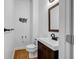 Charming powder room with wood vanity, mirror, toilet, and decorative wall art at 416 Wilfawn Way, Avondale Estates, GA 30002
